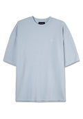 Helles blaues Kurzarm-T-Shirt mit strukturiertem Waffelmuster. Verfügt über einen Rundhalsausschnitt und dezentes Logo-Detail auf der Brust.
