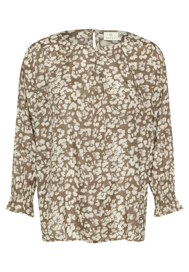 Braune Bluse mit weißem Blumenmuster, langen Ärmeln und gerafften Bündchen. Verfügt über einen Schlüsselaußenschluss am Rücken und einen lockeren, entspannten Schnitt.