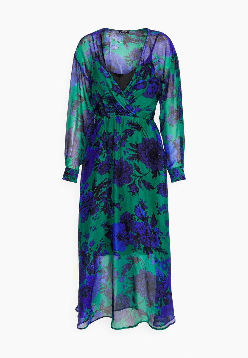 Langes grünes, durchsichtiges Kleid mit blauem und lila Blumenmuster, V-Ausschnitt, langen Ärmeln und geraffter Taille, bei dem das innere schwarze Futter sichtbar ist.
