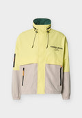 Halb gelbe, halb graue Jacke mit Reißverschluss, hohem Kragen, verstellbaren Kordeln, elastischen Bündchen, Seitentaschen und "Tommy Jeans"-Logo auf der Brust.