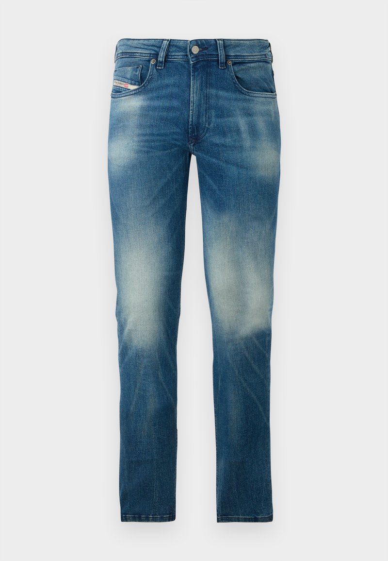Blaue, ausgewaschene Slim-Fit-Jeans mit Fünf-Taschen-Design und Knopfverschluss, präsentiert vor einem schlichten weißen Hintergrund.
