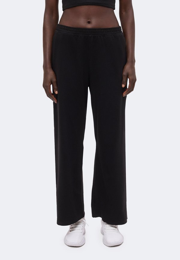 Under Armour MOTION WIDE LEG - Tracksuit bottoms - ultimate black/white