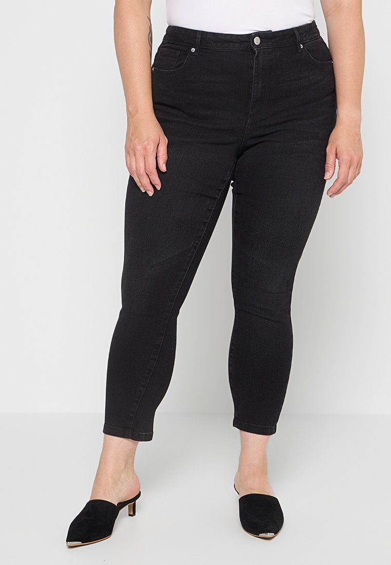 Schwarze Denim-Jeans in Slim-Fit und Knöchellänge. Sie verfügen über einen mittelhohen Bund, ein Fünf-Taschen-Design und einen Metallknopfverschluss.