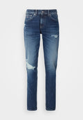 Jeans aus Denim in einem dunklen Waschung mit ausgefransten Details, einschließlich Rissen an den Knien und einem geraden Bein-Schnitt. Mit Metallknopf- und Nietenakzenten.