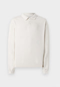 Langärmliges Poloshirt in Off-White, aus weichem Stoff gefertigt. Verfügt über einen klassischen Kragen, drei Knöpfe und gerippte Bündchen. Glatte Textur.