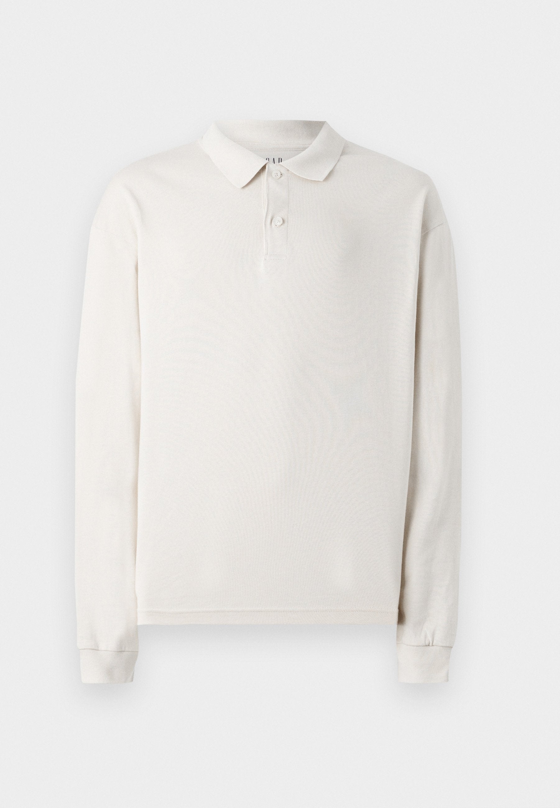 Langärmliges Poloshirt in Off-White, aus weichem Stoff gefertigt. Verfügt über einen klassischen Kragen, drei Knöpfe und gerippte Bündchen. Glatte Textur.