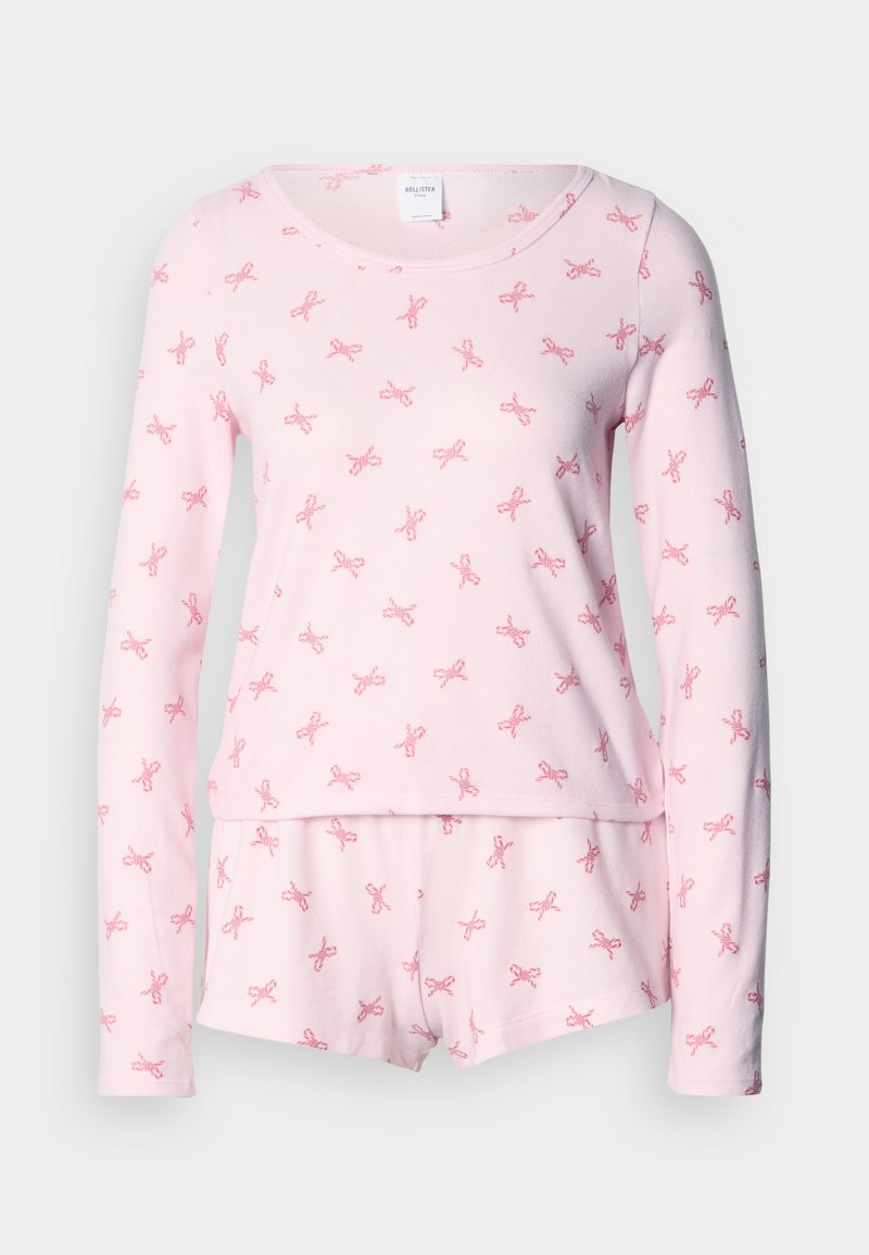 Rosa Pyjama-Set mit langen Ärmeln und Schleifenmustern. Weicher Stoff, Rundhalsausschnitt und passende Shorts mit elastischem Bund.