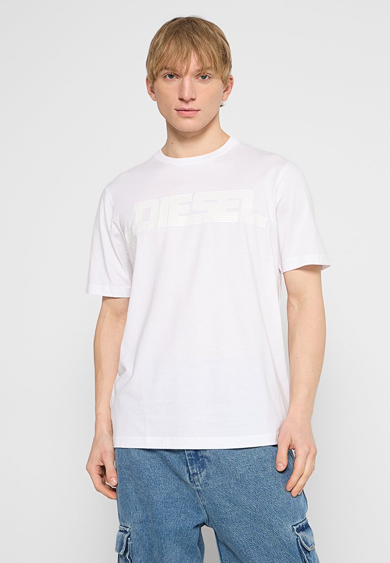 Weißes Baumwoll-T-Shirt mit kurzen Ärmeln und Rundhalsausschnitt, versehen mit einem großen, leicht erhabenen, strukturierten "DIESEL"-Logo über der Brust.