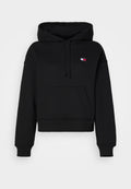 Schwarze, kurze Kapuzenjacke aus weichem Stoff mit einer Fronttasche. Verfügt über eine Kordelzugkapuze und einem kleinen Logo-Patch auf der oberen linken Seite.