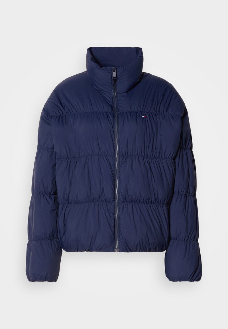 Marineblaue Steppjacke mit hohem Kragen, Reißverschluss, gesteppter Optik und elastischen Bündchen. Verfügt über ein kleines Logo auf der linken Brust.