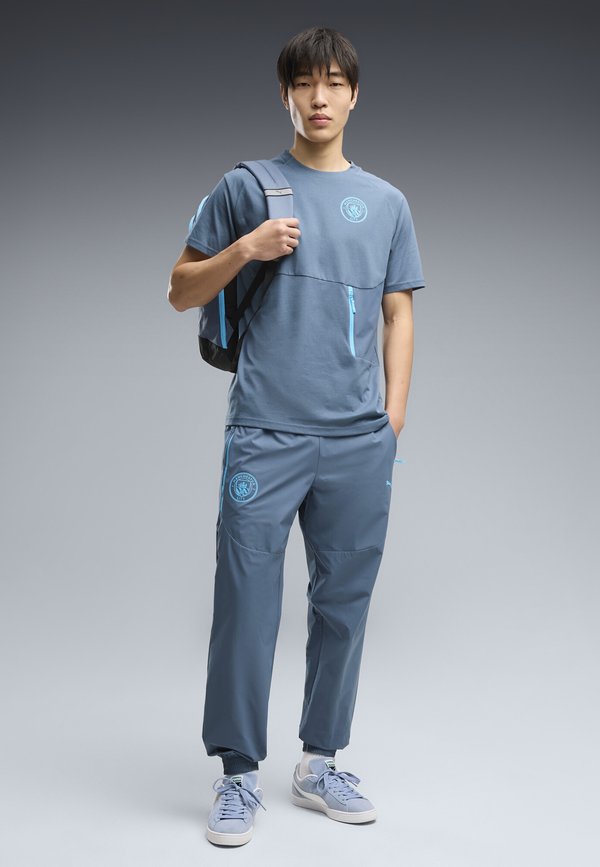 Puma MANCHESTER CITY FC PUMATECH WOVEN PANTS - Tracksuit bottoms - evening sky-luminous blue