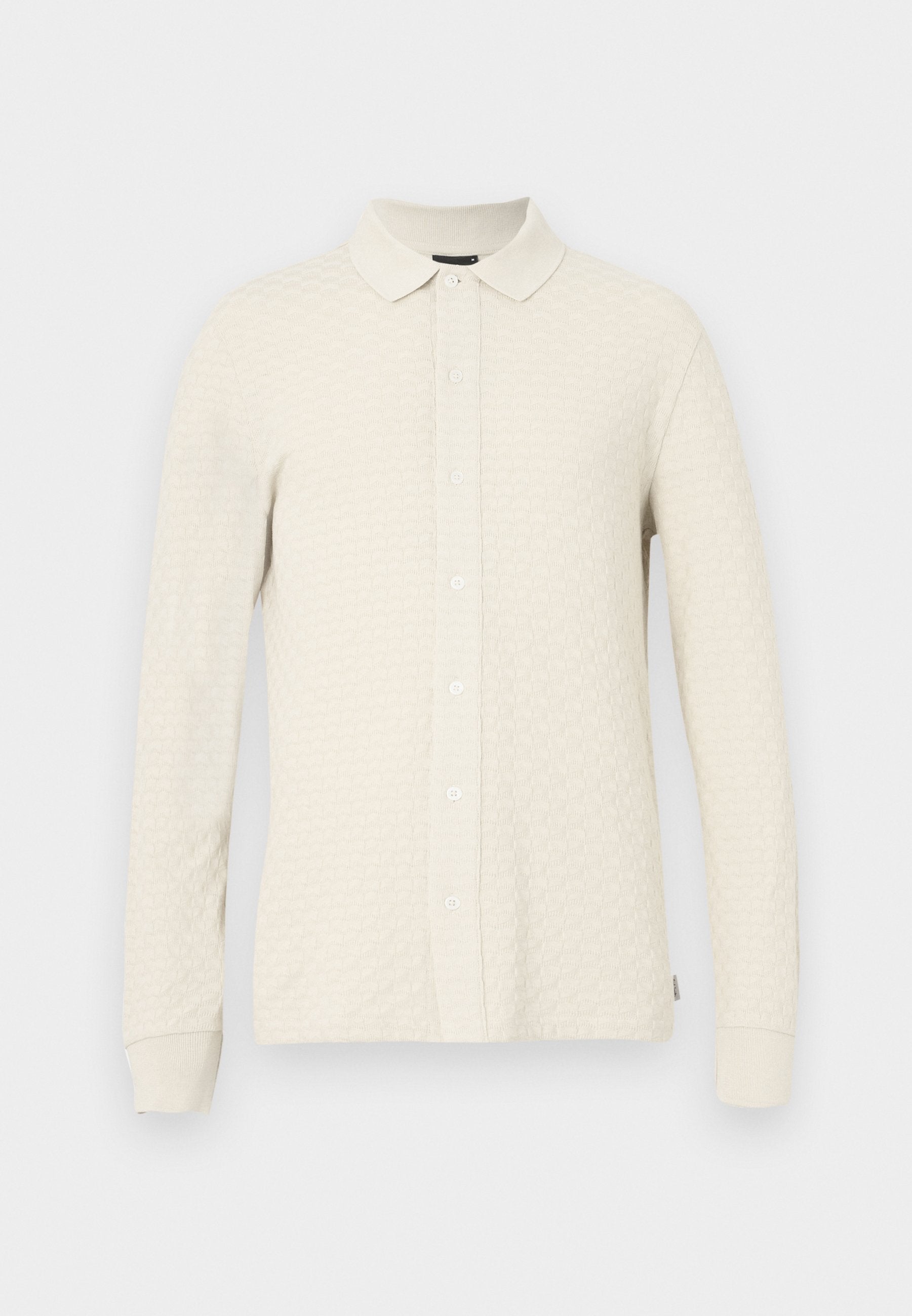 Langärmeliges Polohemd in hellem Beige mit strukturiertem Muster, Kragen und vorderer Knopfleiste. Weiches Material mit gerippten Bündchen.