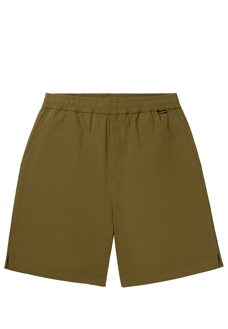 Olivegrüne Shorts mit elastischem Bund, Seitentaschen und einer strukturierten Oberfläche, die dezente seitliche Schlitze am Saum aufweisen.