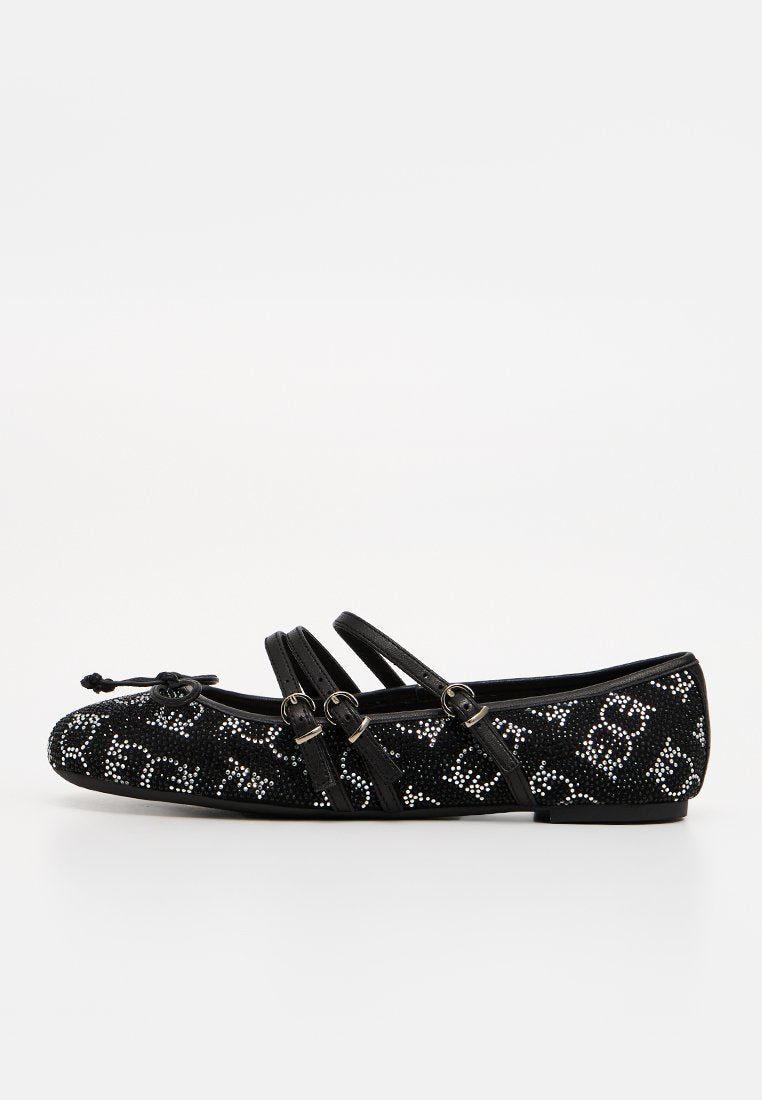 Schwarzer flacher Schuh mit drei Schnallenriemen, verziert mit kleinen weißen Strassmustern und einer Schleife an der abgerundeten Spitze.