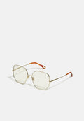 Goldfarbene Metallbrille mit einzigartiger achteckiger Form, ausgestattet mit transparenten Gläsern und orangefarbenen Akzenten an den Bügelenden. Minimalistisches Design.
