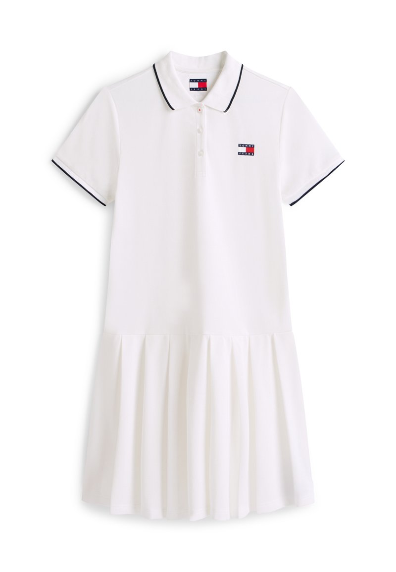 Weißes Polokleid mit kurzen Ärmeln, schwarzem Besatz am Kragen und an den Ärmeln, geknöpfter Blende, plissiertem Rock und kleinem Tommy Jeans Logo auf der Brust.