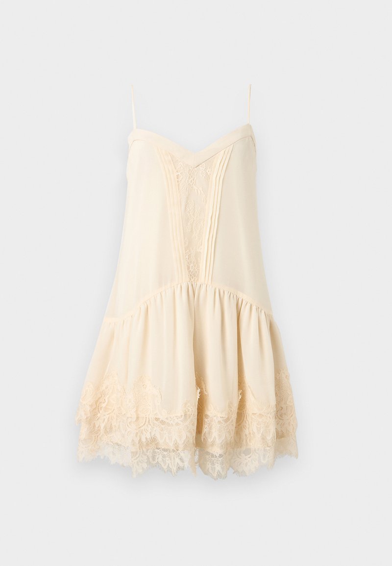 Cremefarbenes ärmelloses Kleid mit Spaghettiträgern, Spitzenverzierung vorne und am Saum sowie einem ausgestellten Rock mit gerafftem Stoff.