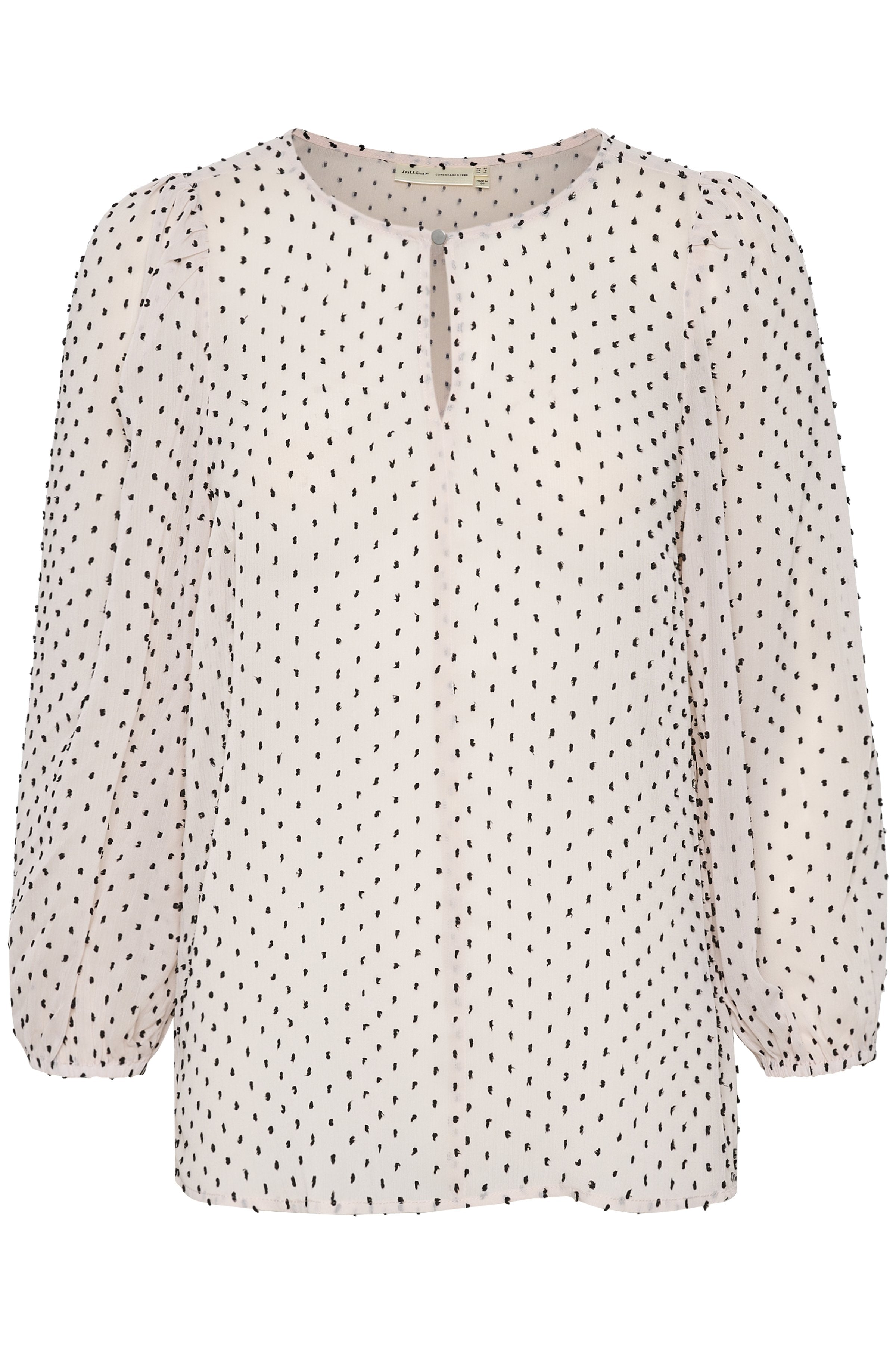Bluse aus leichtem Stoff in sanftem Beige mit schwarzen Pünktchen, Ballonärmeln und einem Ausschnitt mit Schlüsselloch-Detail.