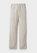 Beige, leichte Jogginghose mit Kordelzug und elastischem Bund, ausgestattet mit dunklen Seitenpaneelen und einem lockeren, geraden Bein-Design.