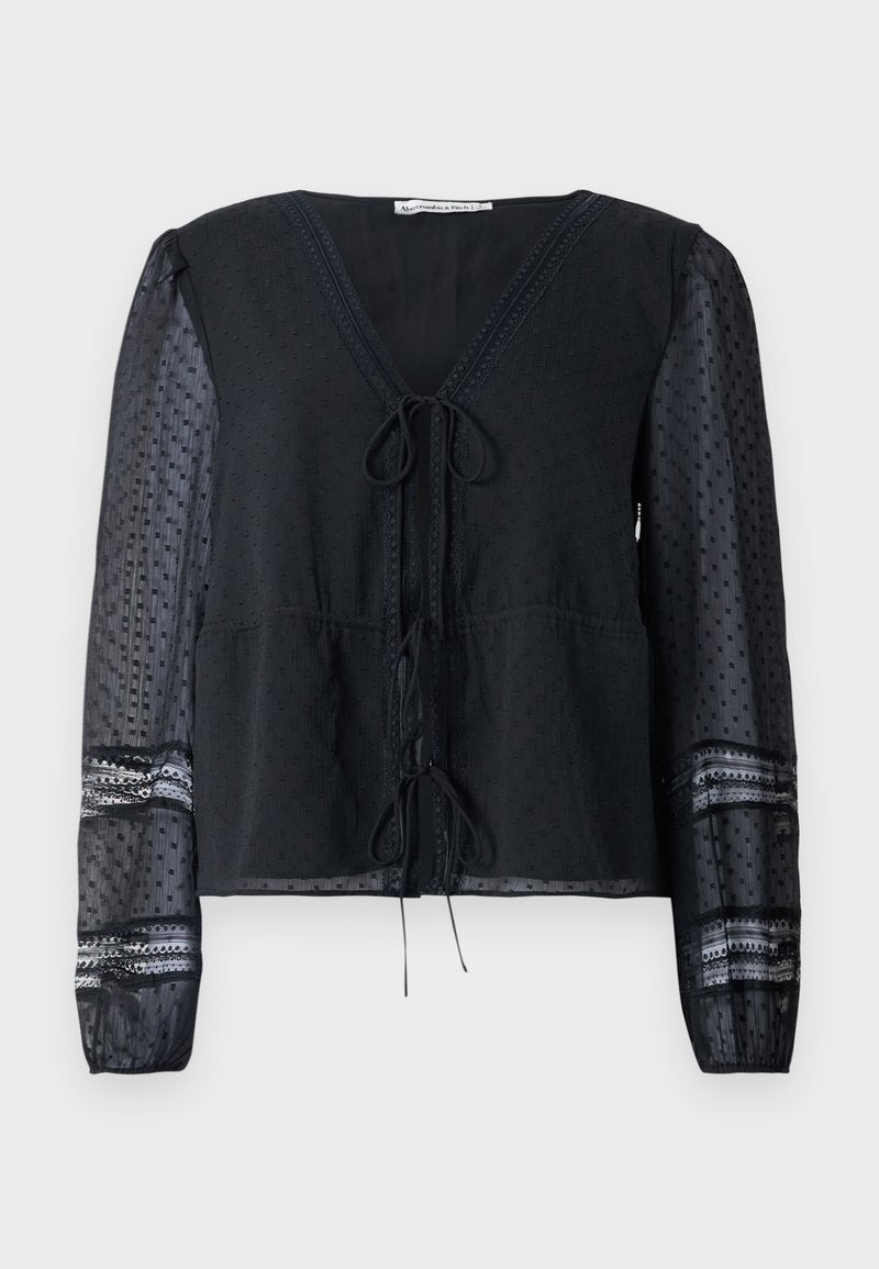 Schwarze halbtransparente Bluse mit langen gepunkteten Ärmeln, Spitzenbesatz, V-Ausschnitt und zwei gebundenen Schleifen auf der Vorderseite.