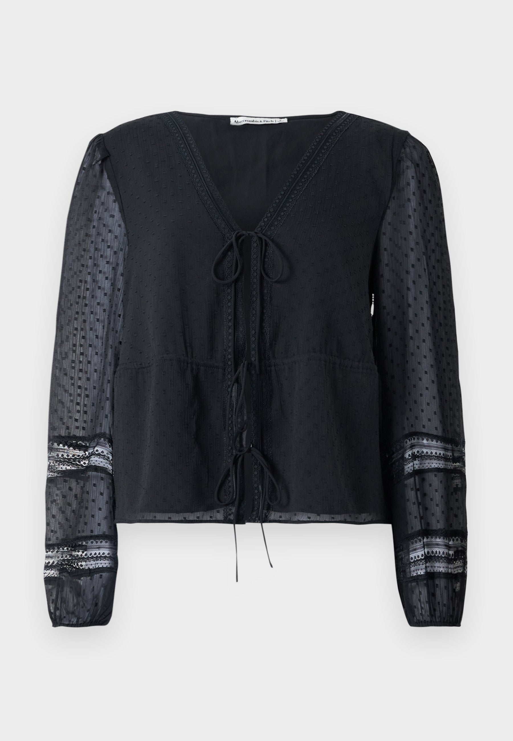 Schwarze halbtransparente Bluse mit langen gepunkteten Ärmeln, Spitzenbesatz, V-Ausschnitt und zwei gebundenen Schleifen auf der Vorderseite.