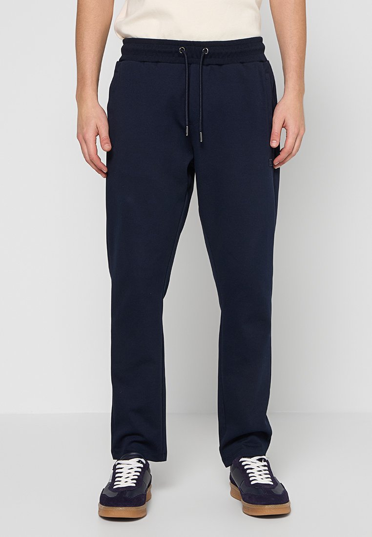 Dunkelblaue Jogginghose aus weichem Stoff mit elastischem Bund und Kordelzug. Verfügt über Seitentaschen und ein tailliertes Bein-Design.