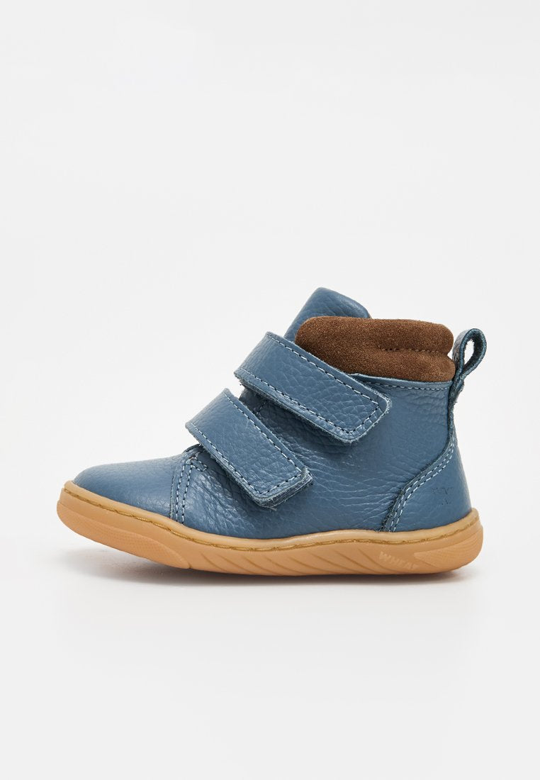 Blauer Leder-Kinderschuh mit zwei Klettverschlüssen, braun gepolstertem Kragen, Zuglasche an der Ferse und hellbrauter, strukturierter Sohle.