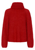 Roter gestrickter Rollkragenpullover mit lockerer Passform, ausgestattet mit einem strukturierten Material und langen Ärmeln. Der Halsausschnitt ist weit und gerippt.
