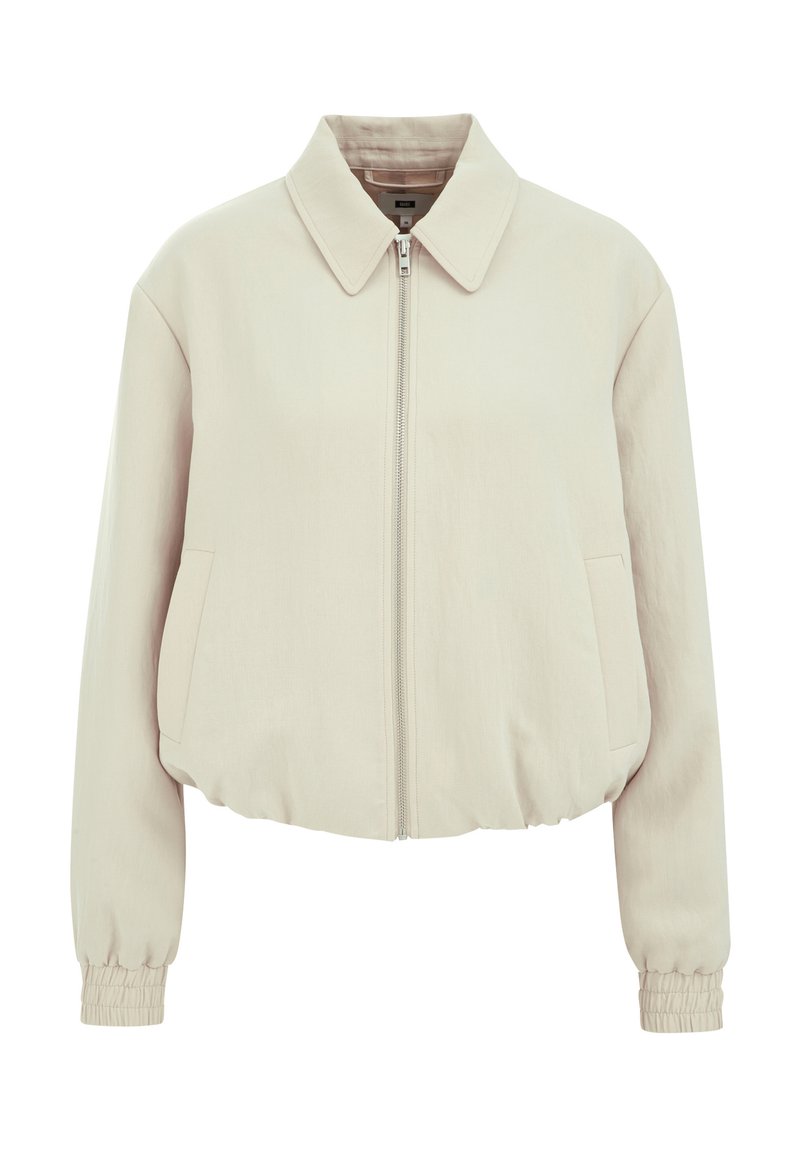 Beige kurz geschnittene Jacke mit Reißverschlussfront, flachem Kragen, zwei Seitentaschen und elastischen Bündchen. Glattes Material mit subtiler Farbreflexion.
