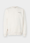 Hellbeige Sweatshirt aus weichem Material, mit Rundhalsausschnitt und gerippten Bündchen. Auf der Brust befindet sich das schwarze "TOMMY JEANS" Logo.