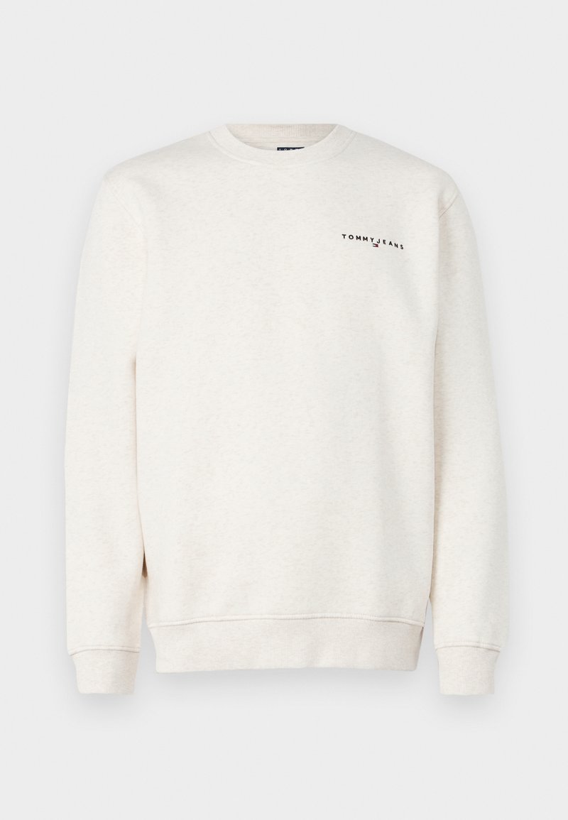 Hellbeige Sweatshirt aus weichem Material, mit Rundhalsausschnitt und gerippten Bündchen. Auf der Brust befindet sich das schwarze "TOMMY JEANS" Logo.