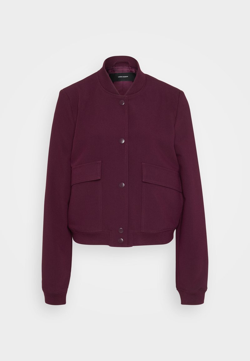 Burgunderfarbene Bomberjacke mit rundem Ausschnitt, zwei vorderen Taschen und Druckknopfverschluss. Weicher Stoff mit gerippten Bündchen und Saum.