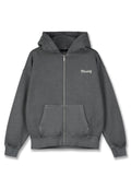 Grauem Zip-Up Hoodie aus weichem Stoff mit einer Vordertasche, umgeschlagenen Bündchen und einer großen Kapuze. "PEGA-DOR" in Weiß auf der Brust gedruckt.