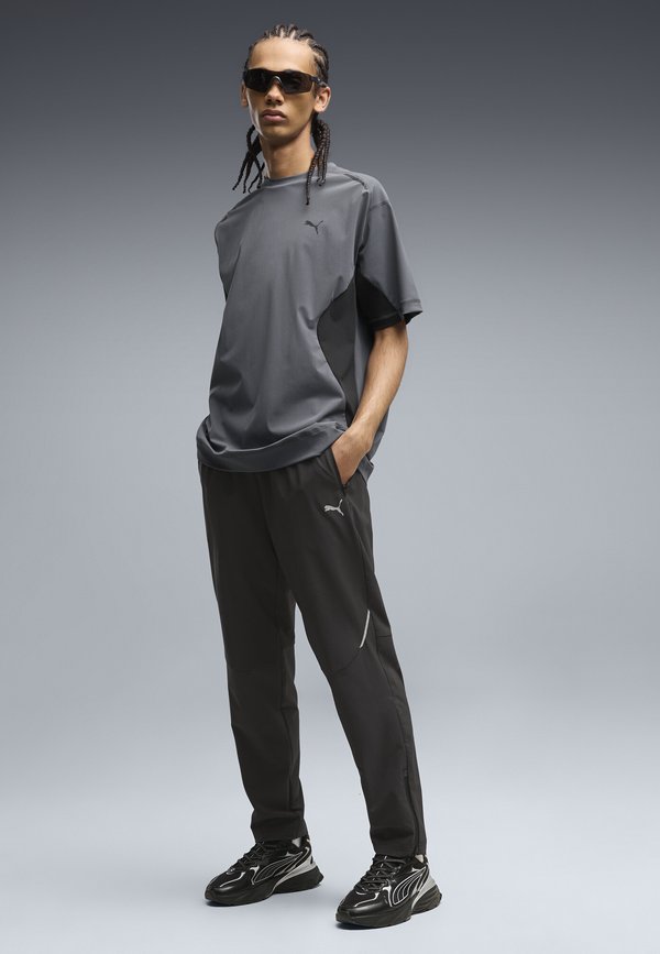 Puma PUMATECH  - Tracksuit bottoms - black