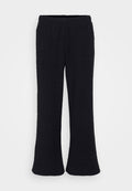 Schwarze, ausgestellte Hosen aus einem strukturierten Stoff mit einem elastischen Bund. Das Design ist bodenlang mit einem weichen Finish.