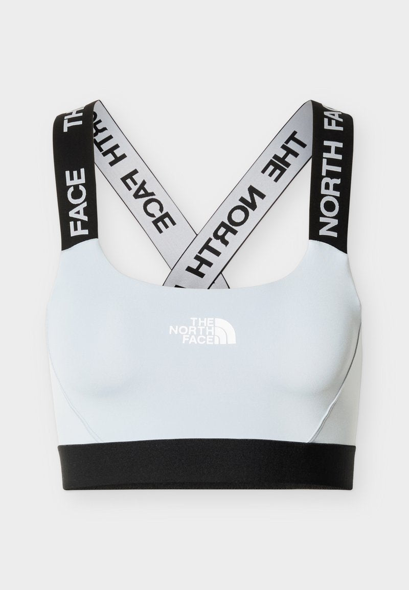 Hellblauer Sport-BH mit schwarzem elastischem Bund und gekreuzten schwarz-weißen Trägern mit "THE NORTH FACE"-Logo.