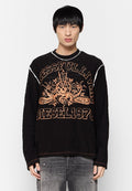 Schwarzes Langarmshirt mit oranger Grafikschrift "DIESEL1978" und dekorativen Elementen. Verfügt über Kontrastnähte und einen lässigen Schnitt.
