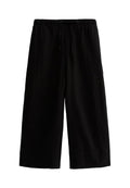 Schwarze weit geschnittene Hose aus leichtem Stoff, mit einem elastischen Bund und einem Kordelzug sowie einer glatten Textur.