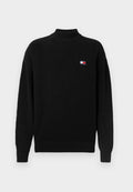 Schwarzer, gestrickter Rollkragenpullover mit geribbeltem Muster und lockerer Passform. Verfügt über ein kleines, buntes Logo-Patch auf der linken Brust.