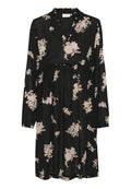 Schwarzes Kleid mit langen Ärmeln, einem V-Ausschnitt und einem gerafften Bund. Verfügt über ein florales Muster in hellrosa. Hergestellt aus leichtem Stoff.