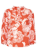 Rote Bluse mit langen Ärmeln, die weiße Blumenmuster aufweist, einen V-Ausschnitt hat und geraffte Details an den Ärmeln besitzt. Glatte Stofftextur.