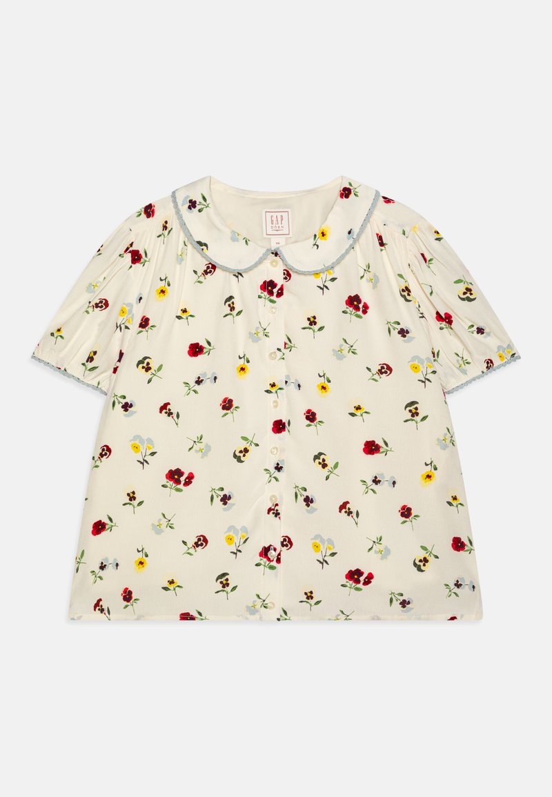 Kurzärmlige, kragenlose Bluse aus cremefarbener Stoff mit einem floralem Muster in Rot, Gelb und Blau, ausgestattet mit einer Knopfleiste und Rüschensäumen.