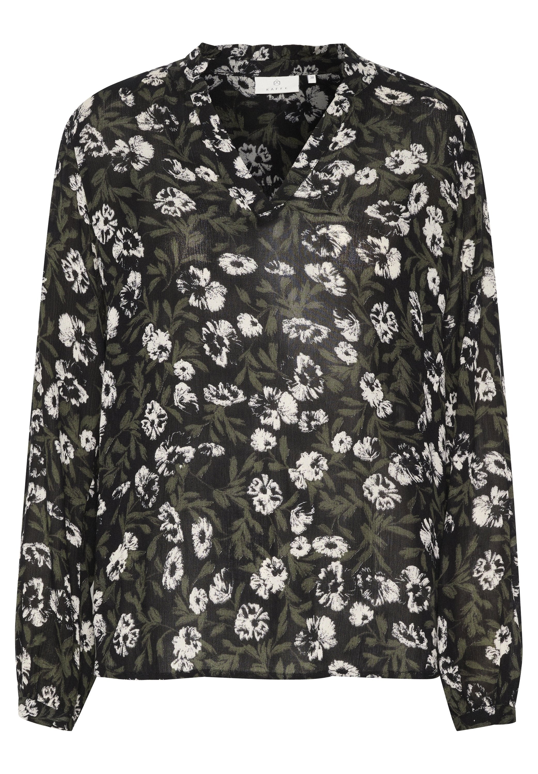 Blumige Bluse mit schwarzem Hintergrund und weißen sowie grünen Blumen, langen Ärmeln und V-Ausschnitt. Hergestellt aus leichtem, transparentem Stoff.