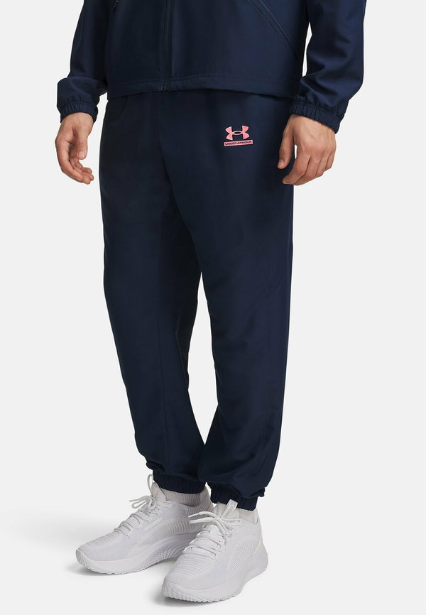 Under Armour TECH SPORT - Tracksuit bottoms - academy