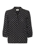 Schwarze Bluse mit weißem Diamantenmuster, mit einem Kragen, Knopfleiste und 3/4 Ballonärmeln. Glatte Stofftexture.
