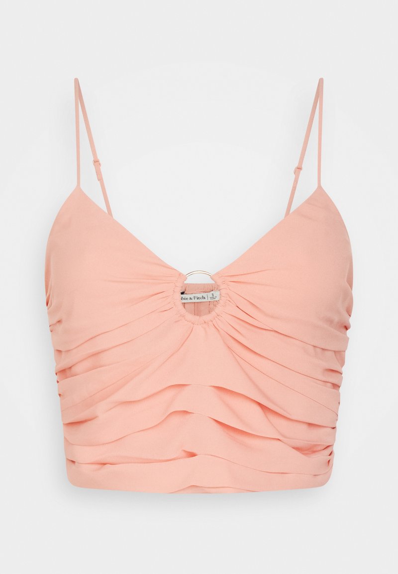 Pfirsichfarbener Croptop aus strukturiertem Stoff, mit gerafften Details und einem kreisförmigen Akzent sowie dünnen verstellbaren Trägern.