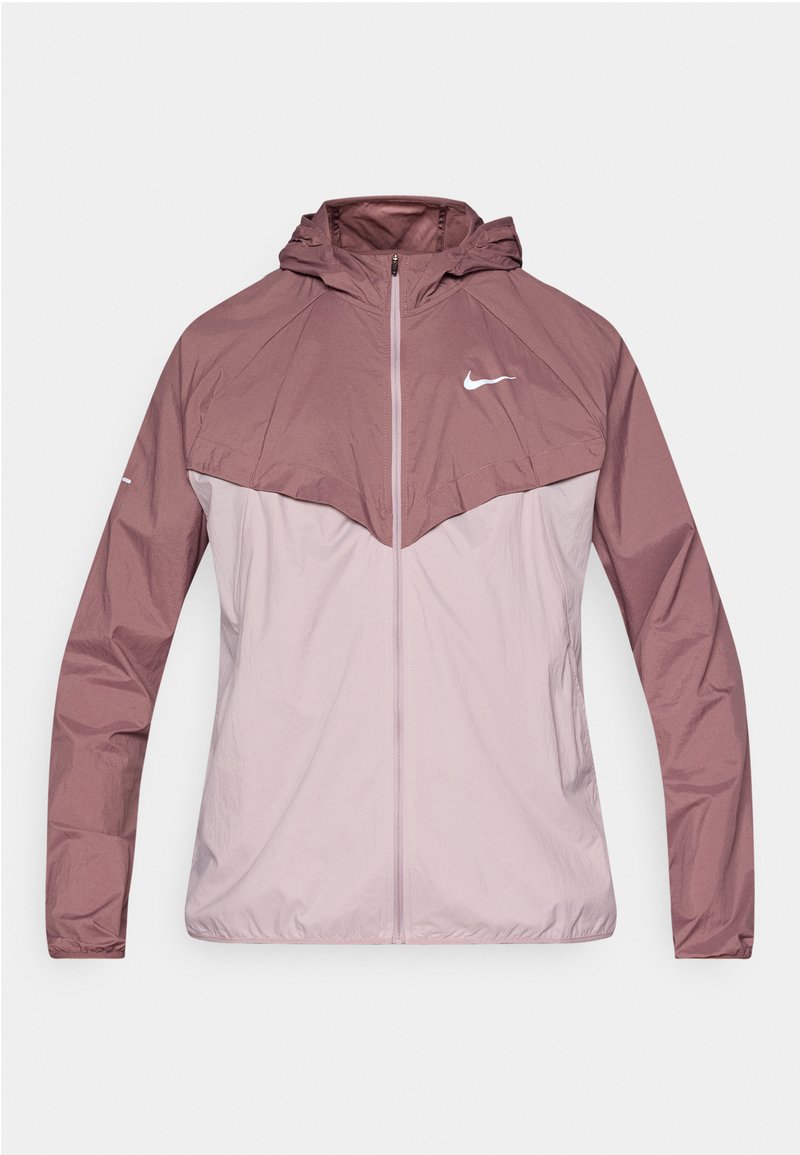 Nike Windbreaker-Jacke mit zweifarbiger Gestaltung in Mauve und Hellrosa, aus leichtem Material mit Kapuze und Frontreißverschluss.