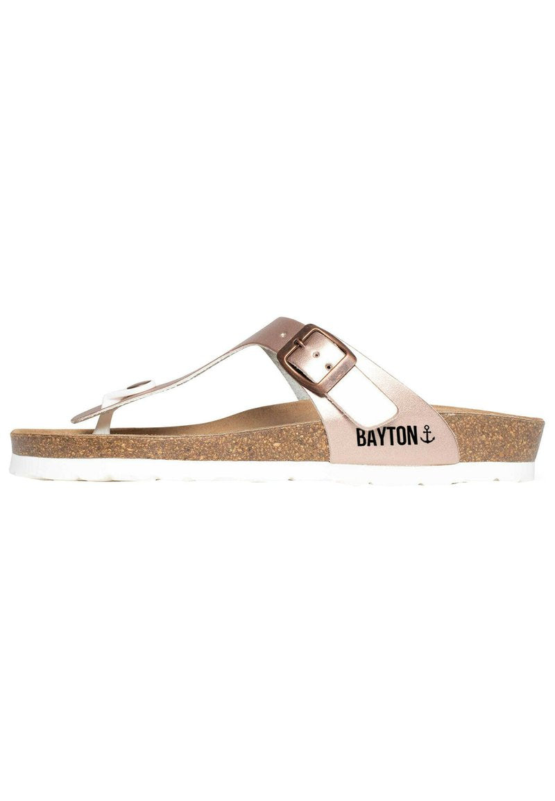 Flip-Flop-Sandal mit einem metallisch rosegoldenen Riemen mit Schnalle, Korkzwischensohle und weißer Gummi-Außensohle. Markenname "BAYTON" sichtbar.