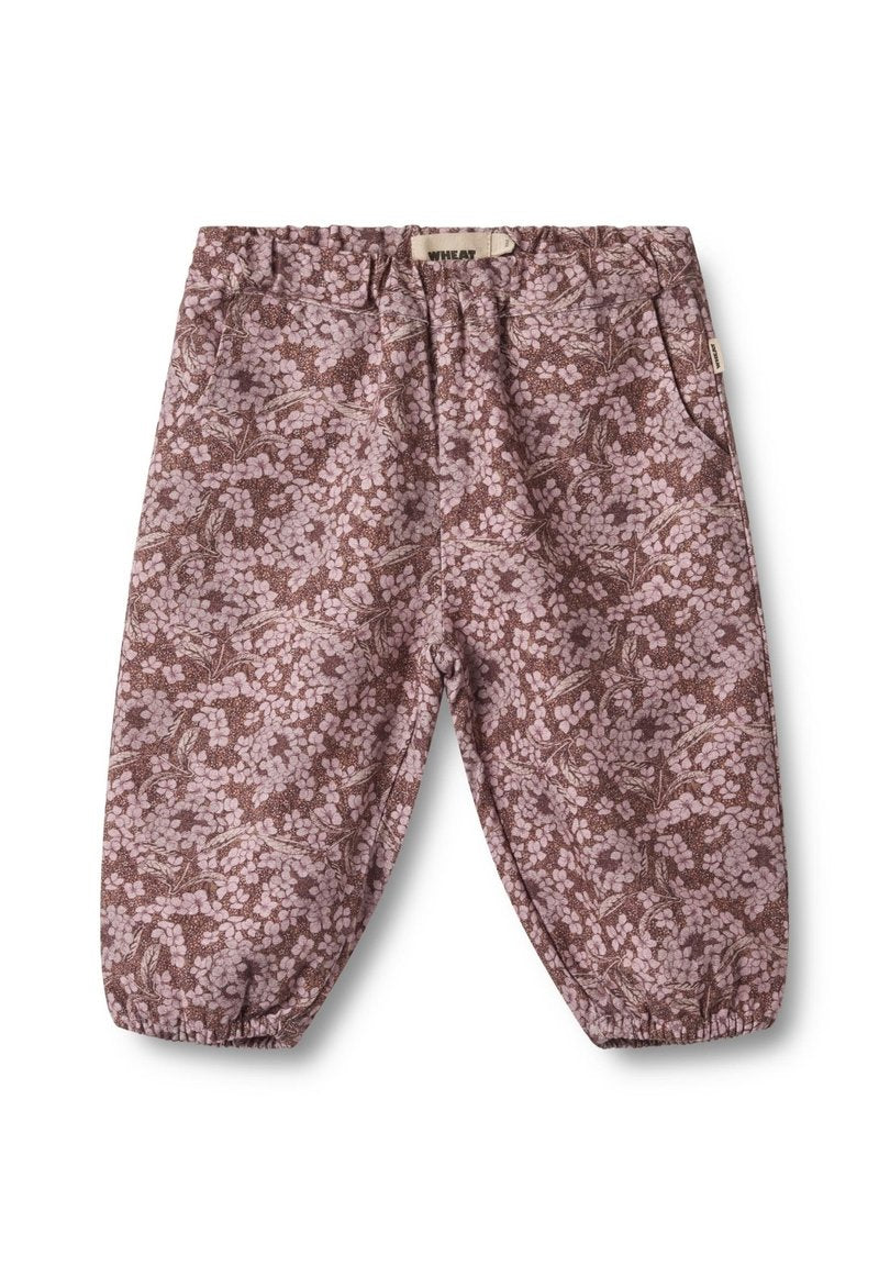 Braune und rosa, blumenmusterte Hosen mit elastischem Bund, gerafften Bündchen und Seitentaschen. Hergestellt aus weichem, leichtem Stoff.