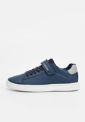 Marineblauer Sneaker mit weißer Sohle, elastischen Schnürsenkeln und einem Klettverschluss mit der Aufschrift "GEOX", ausgestattet mit einem weißen Fersenpatch und einem flachen Schnitt.